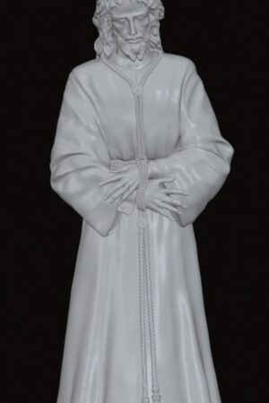 White statue of Jesus Christ in a long robe with a braided belt, hands crossed, and a spiked radiating halo on a pedestal.